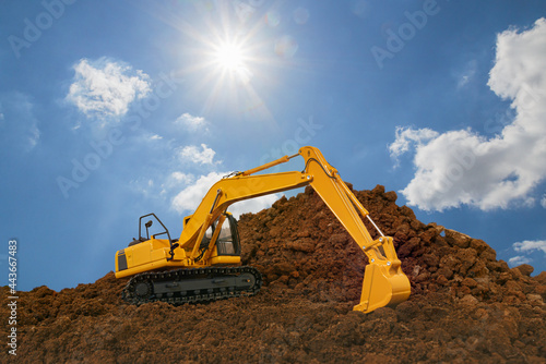 Crawler Excavator digging the soil In the construction site area with on blue sky and sunbeam background