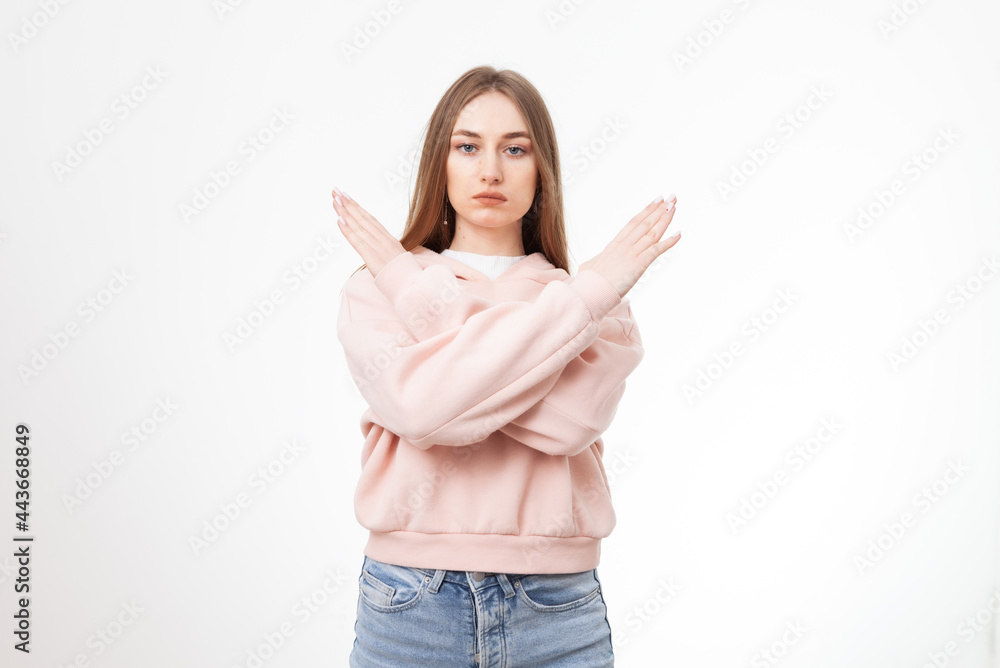 Young serious woman holding arms crossed isolated on white background Young serious woman holding arms crossed isolated on white background