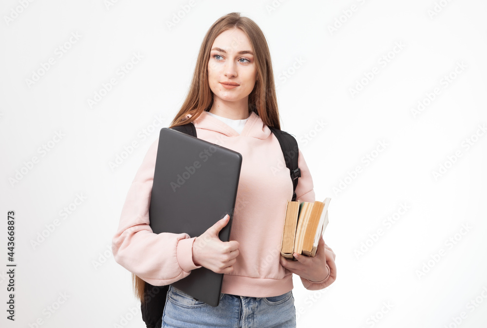 Young attractive caucasian woman student with backpack, laptop and books isolated on white background