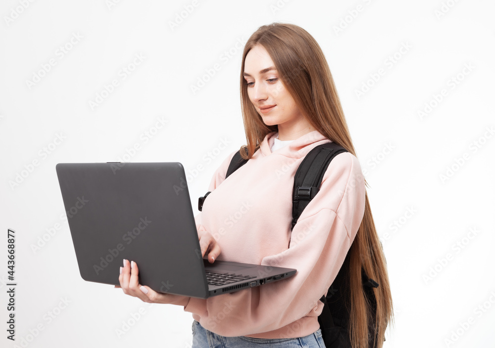 Young attractive caucasian woman student with backpack and laptop isolated on white background Young attractive caucasian woman student with backpack and laptop isolated on white background