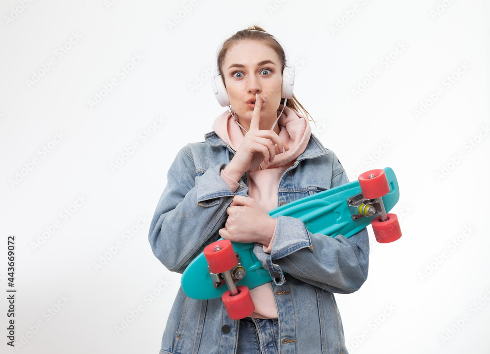 Young hipster woman showing finger silence gesture on white background Young hipster woman showing finger silence gesture on white background
