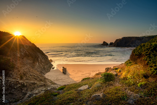 Landscape with sunset over Portuguese West coast and sandy Praia das Adegas photo