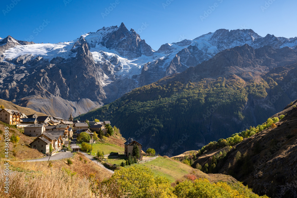 La Meije peak in Ecrins National Park with the village of Le Chazelet and glacier in Autumn. Hautes-Alpes, French Alps, France