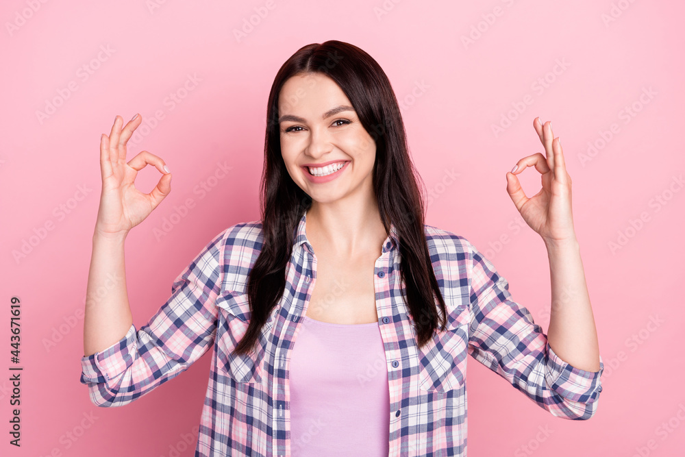 Portrait of attractive glad cheerful girl showing double ok-sign ad isolated over pink pastel color background Portrait of attractive glad cheerful girl showing double ok-sign ad isolated over pink pastel color background