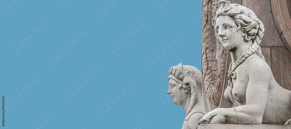 Banner with two statues of beautiful Egyptian sphinx at Obelisk in historical downtown of Potsdam, Germany, with copy space and blue sky solid background. Banner with two statues of beautiful Egyptian sphinx at Obelisk in historical downtown of Potsdam, Germany, with copy space and blue sky solid background.