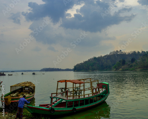 Boat in kaptai lake with beautyfil sky and green background 
