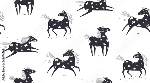 Wild abstract horse seamless pattern, horses running in the field with flowers on white, scandinavian style freehand animal doodle monochrome background. Vector hand drawn textile design.