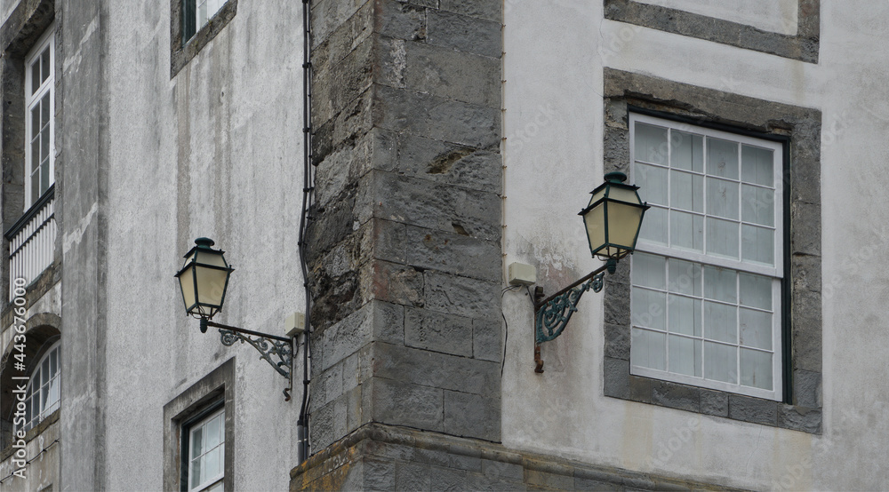 old street lamps on the stone wall of a traditional building, Azores, Horta