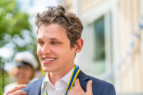 Canvas Print Closeup summer portrait of a young man at a graduation ceremony outdoors