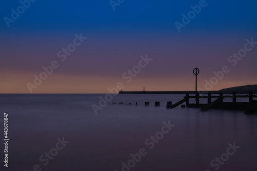 Long Exposure of Aberdeen Beach with lighthouse and breakwater pier. located in Aberdeenshire  Scotland.