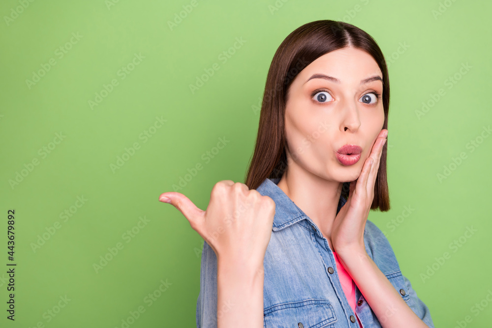 Profile side photo of young girl amazed surprised hand touch cheek point thumb ad promo suggest isolated over green color background Profile side photo of young girl amazed surprised hand touch cheek point thumb ad promo suggest isolated over green color background
