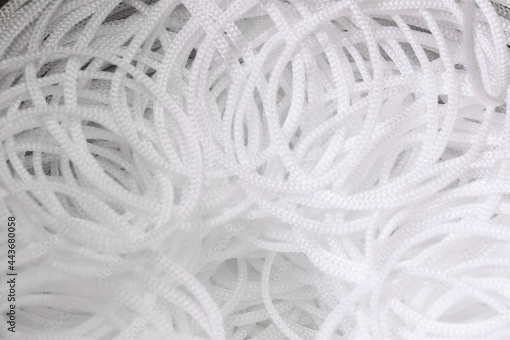 Background of pattern white synthetic cord. Industrial production of cords. Top view. Background of pattern white synthetic cord. Industrial production of cords. Top view.