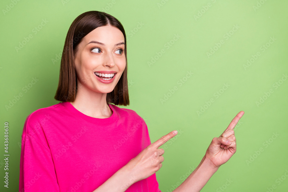 Photo of funny brunette hair millennial lady point look empty space wear pink t-shirt isolated on green color background Photo of funny brunette hair millennial lady point look empty space wear pink t-shirt isolated on green color background