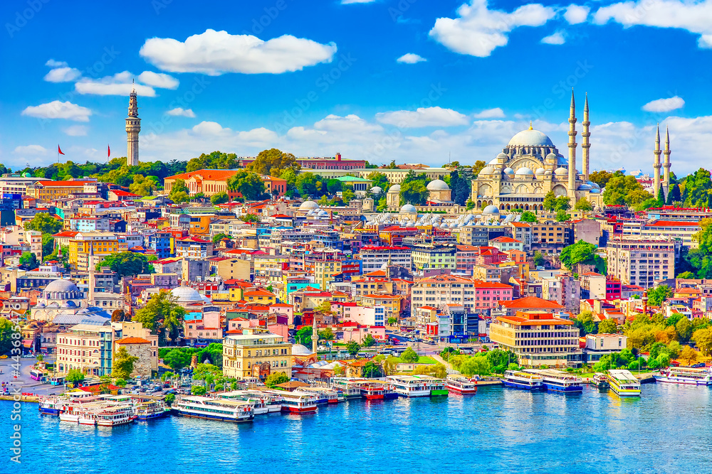 Naklejka premium Touristic sightseeing ships in Golden Horn bay of Istanbul and mosque with Sultanahmet district against blue sky and clouds. Istanbul, Turkey during sunny summer day.