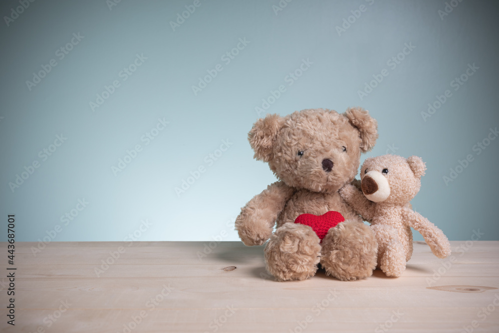 Concept family, love, and valentines festival. Big and little brown teddy bears sitting huggy show love, happiness on an old wooden table with copy space. Concept family, love, and valentines festival. Big and little brown teddy bears sitting huggy show love, happiness on an old wooden table with copy space.