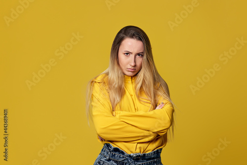 upset unsatisfied woman on yellow background. Human emotions