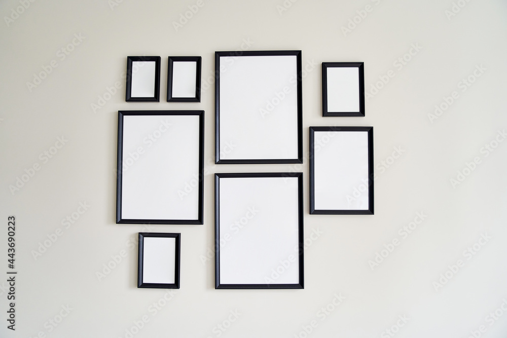 Different size framed photos hanging on the gray wall. Mockup. Different size framed photos hanging on the gray wall. Mockup.