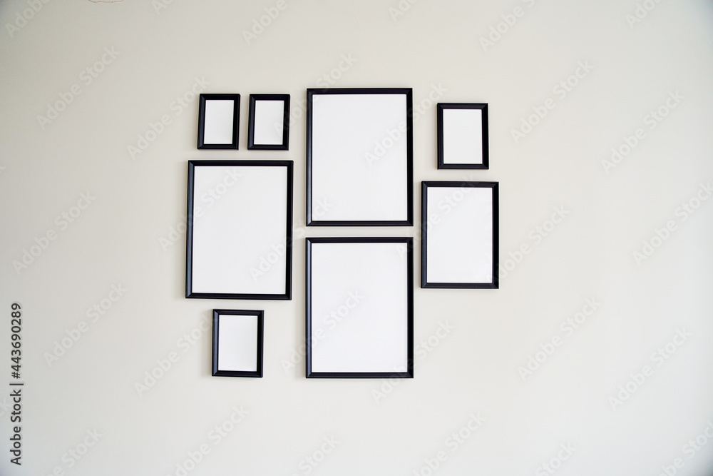 Different size framed photos hanging on the gray wall. Mockup. Different size framed photos hanging on the gray wall. Mockup.