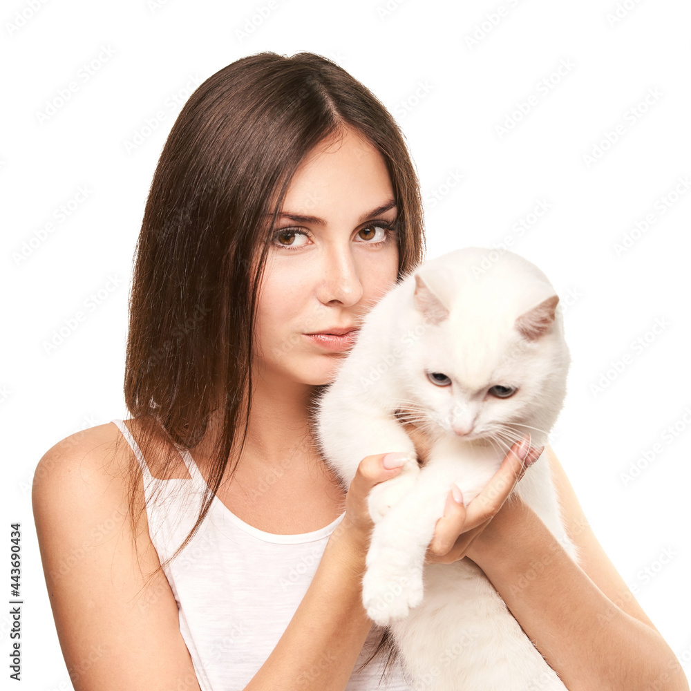 Young woman holding white cat. Allergy concept. Pretty animal. Lifestyle. Human and pet Young woman holding white cat. Allergy concept. Pretty animal. Lifestyle. Human and pet