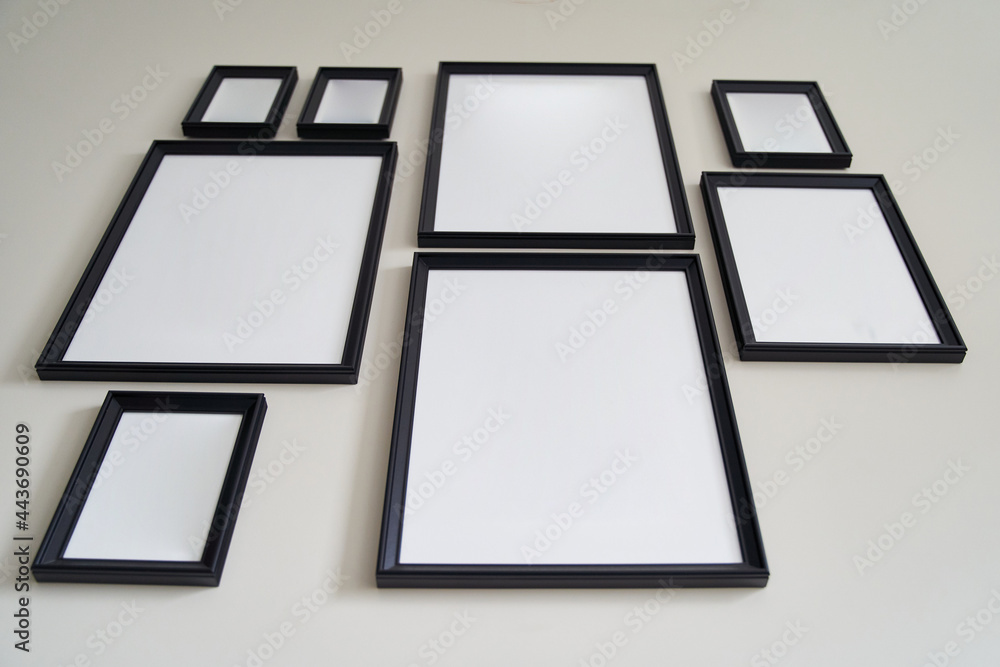 Different size framed photos hanging on the gray wall. Mockup. Different size framed photos hanging on the gray wall. Mockup.