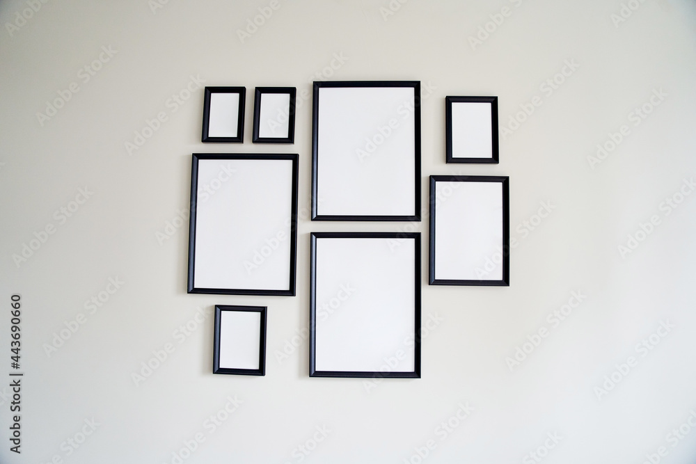 Different size framed photos hanging on the gray wall. Mockup. Different size framed photos hanging on the gray wall. Mockup.