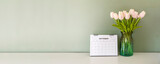 Calendar desk and flower on table. Desktop Calender for Planner to plan agenda, timetable, appointment, organization, management each date, month on office table. Calendar Concept-panoramic banner