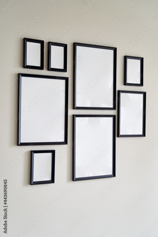 Different size framed photos hanging on the gray wall. Mockup. Different size framed photos hanging on the gray wall. Mockup.