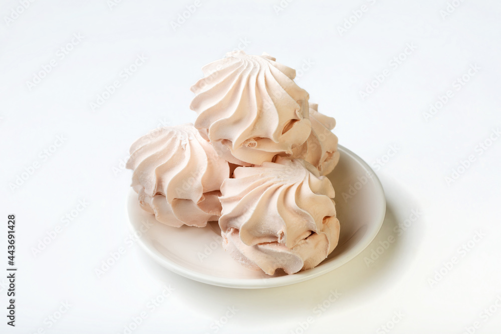 Sweets. Sweet apple marshmallows on a white plate. Marshmallow on a white background for insulation. Sweets. Sweet apple marshmallows on a white plate. Marshmallow on a white background for insulation.