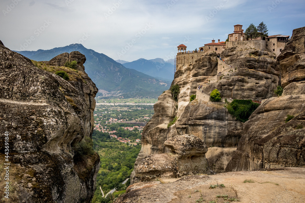 Meteora, Greece, monastery on top of the mountain hill. Scenery summer view with cloudy sky.