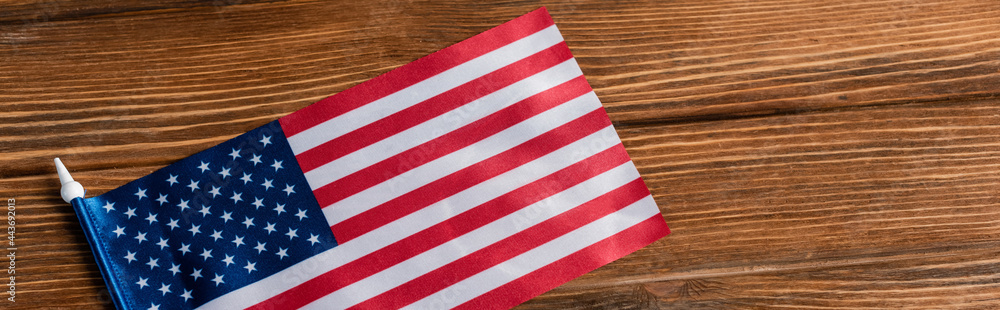 top view of small american flag on wooden surface, banner top view of small american flag on wooden surface, banner
