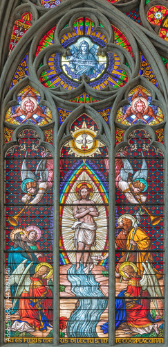 VIENNA, AUSTIRA - JUNI 24, 2021: The Baptism of Jesus on the stained glass in the Votivkirche church originaly by workrooms from Austria.