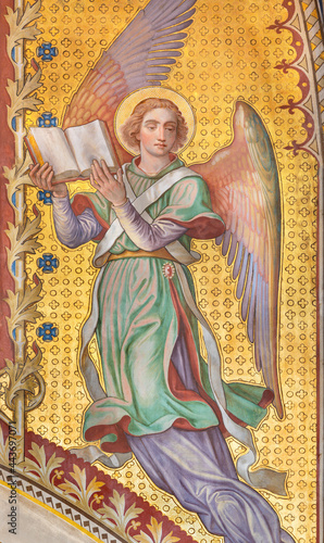 VIENNA, AUSTIRA - JUNI 24, 2021: The fresco of angel with the book in the Votivkirche church by brothers Carl and Franz Jobst (sc. half of 19. cent.). photo