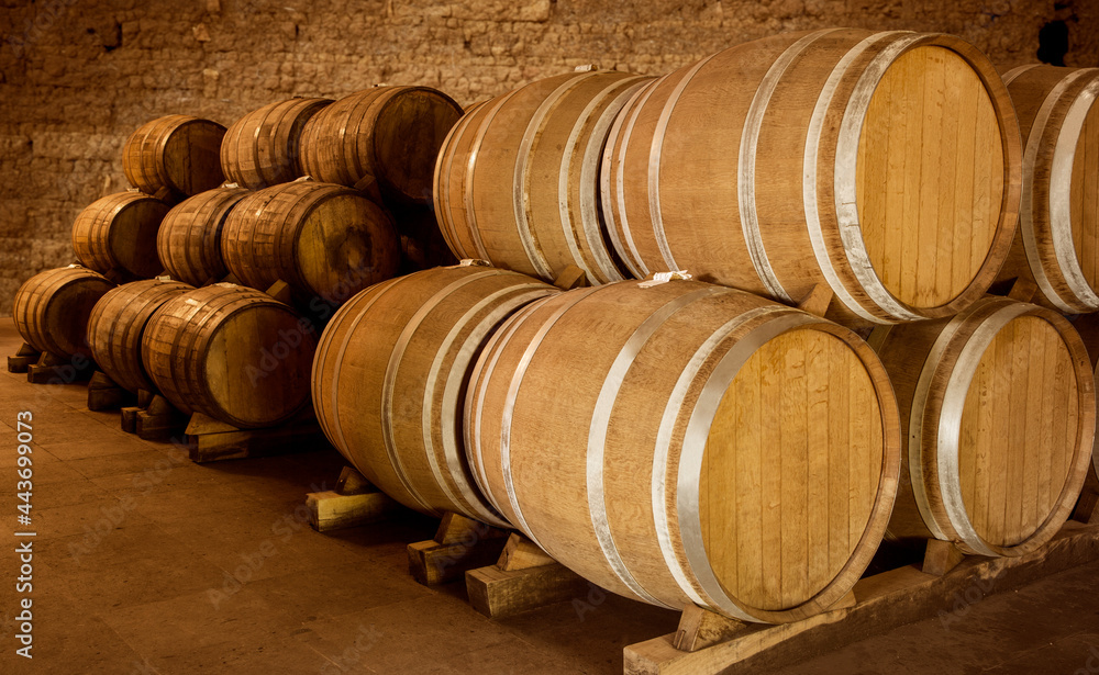 Wine barrels on old cellar. Warm and desaturated tones Wine barrels on old cellar. Warm and desaturated tones