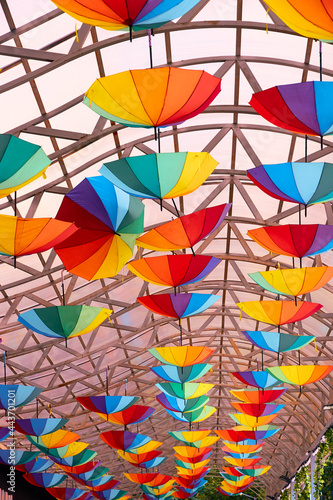 colorful umbrellas painted in the colors of the rainbow suspended on a canopy