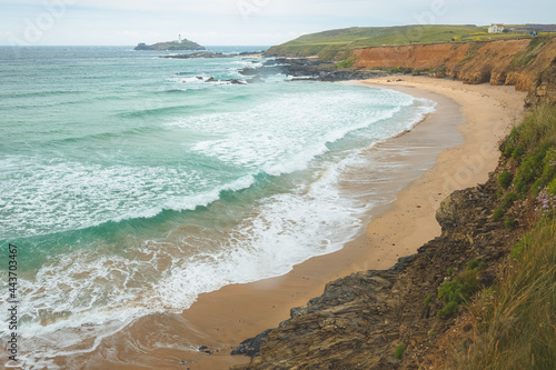 Scenic seascape landscape of sandy beach along Godrevy Point and Godrevy Lighthouse on the Cornish Atlantic coast in Cornwall, England, UK. photo