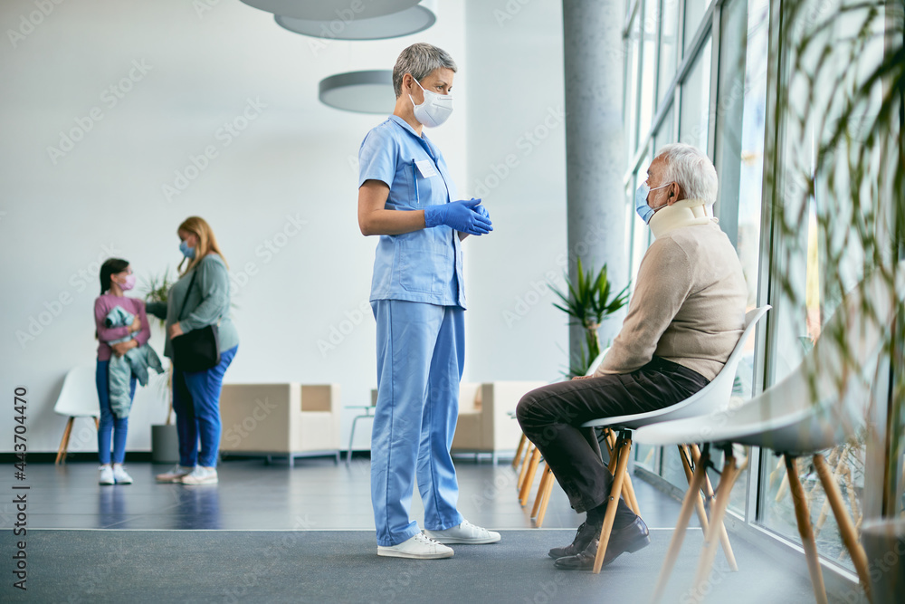 Senior man with neck injury and radiologist wearing face masks while communicating in waiting room at medical clinic. Senior man with neck injury and radiologist wearing face masks while communicating in waiting room at medical clinic.