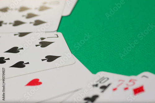 Classic playing cards on green background. Gambling and casino concept.