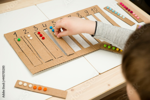 Put correct strap with balls of cotton wool to assigned cavity with number. Preschool educational aid for kindergartens. children early learning montessori kit for intelligence.