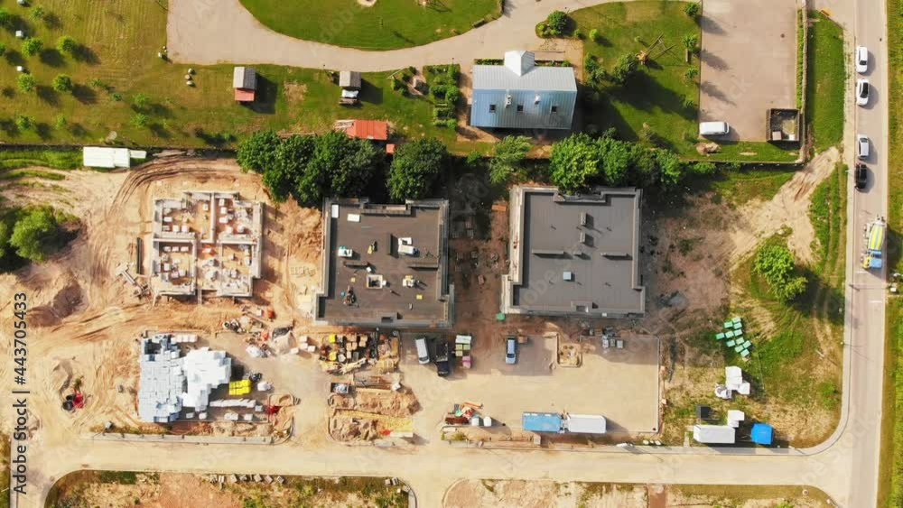 Top down view three buildings roof tops in construction site in residential area. Real estate development concept. Top down view three buildings roof tops in construction site in residential area. Real estate development concept.