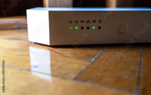 Advance white wifi router, Asymmetric digital subscriber line modem with lights blinking showing internet data activation.