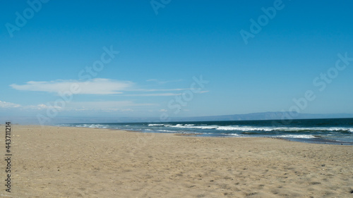  seashore in the summer sun, beautiful scenery, straw umbrellas