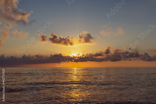 A trite dull photo of a sunset over the sea. Typical amateur photography from a seaside vacation photo