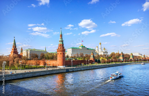 View of the Kremlin and a boat on the Moskva River in Moscow