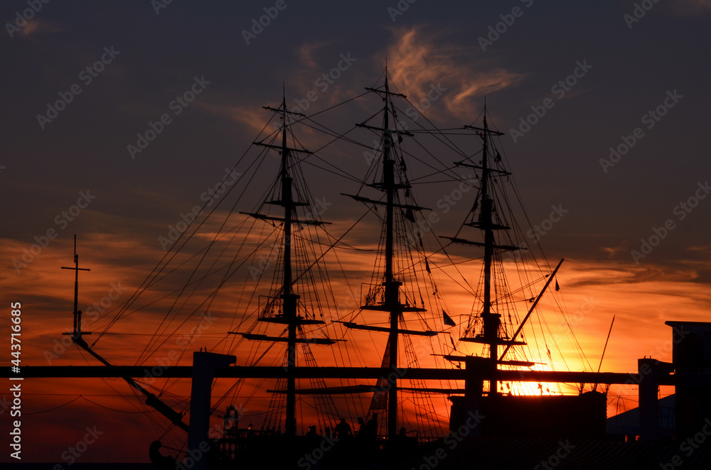 silhouette of the ship's hull against the sunset sky
