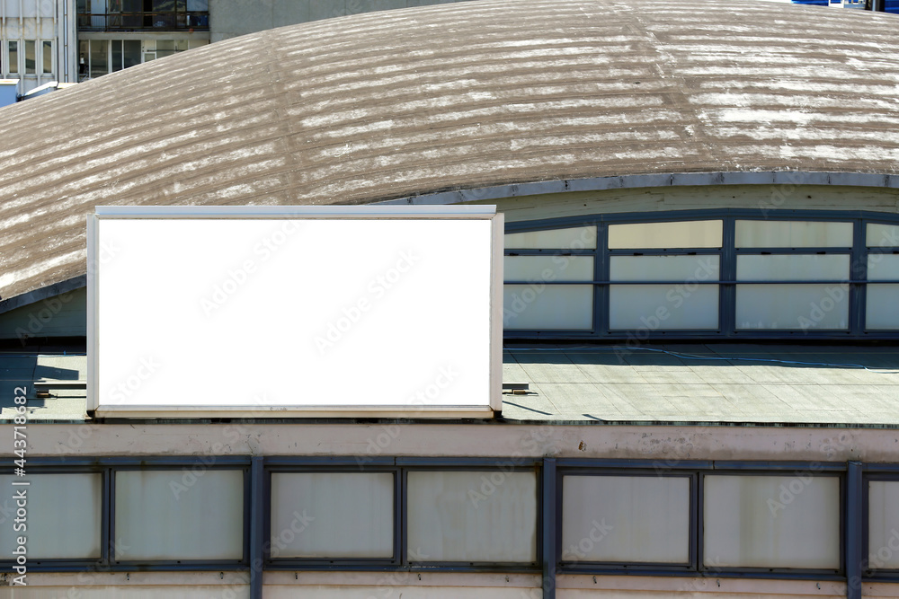 Large blank billboard for outdoor advertising poster on the roof of a big industrial building. Large blank billboard for outdoor advertising poster on the roof of a big industrial building.