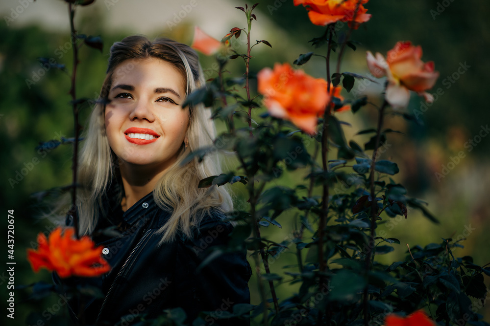 Naklejka premium portrait of a beautiful girl close-up in flowers in the garden