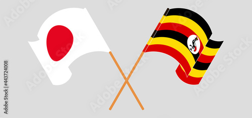 Crossed and waving flags of Japan and Uganda