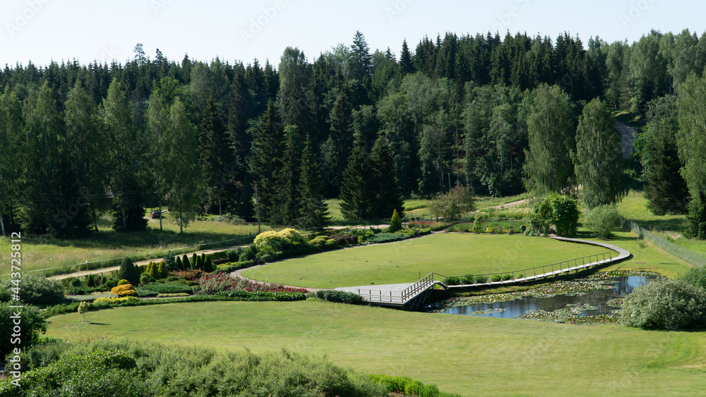 The garden in a hotel territory. Landscape design of landscaped territory in a rural area in the territory of Latvia. View from the loggia of the hotel deluxe room. Sigulda region, Latvia.