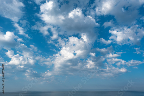 white fluffy clouds on blue sky in summer © Ms VectorPlus