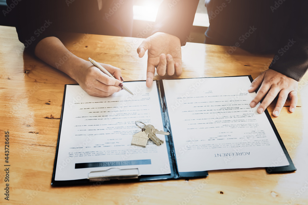Obraz premium estate agent gives pen and documents agreement with customer to sign contract. Concept agreement.
